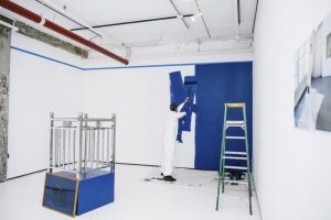 Manufracture Series: Steel and Benjamin Moore installation and live Performance/ stainless steel fence, C-Print, paint, painting tools and accessories, a wooden pedestal, a frame, and live performance dimensions variable 2016
