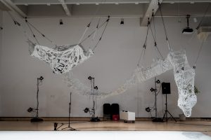 Photograph of an art installation with suspended string hammocks by artist Astrid Lloyd, resident at GlogauAIR 2019