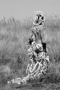 Photograph of costume being worn by woman stood facing away from camera by artist Astrid Lloyd, resident at GlogauAIR 2019