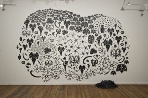 Photograph of black illustrations on a white wall by artist Heloisa Pomfret, resident at GlogauAIR 2019