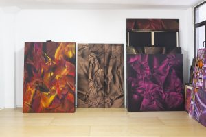 Photograph of three paintings against a wall by artist Ismael Iglesias, resident artist at GlogauAIR 2019