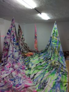 Photograph of painted fabric in different colours by artist Ismael Iglesias, resident artist at GlogauAIR 2019