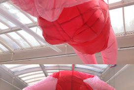 Large scale balloon installation of pink woman in swimsuit
