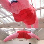 Large scale balloon installation of pink woman in swimsuit